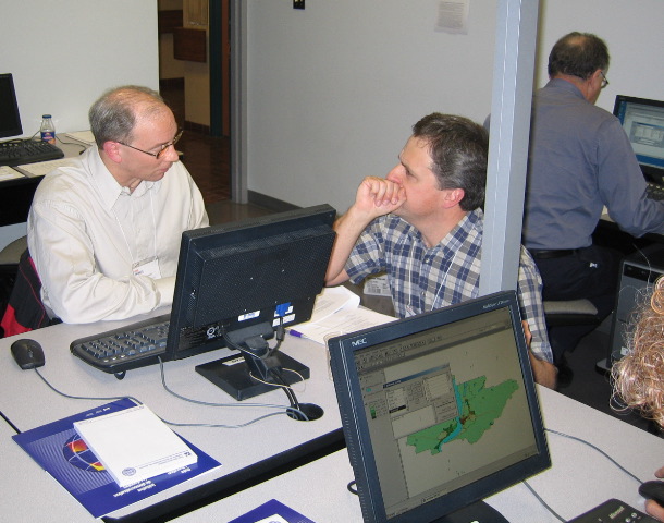 Lee and Peter compare notes while maps emerge on monitors.